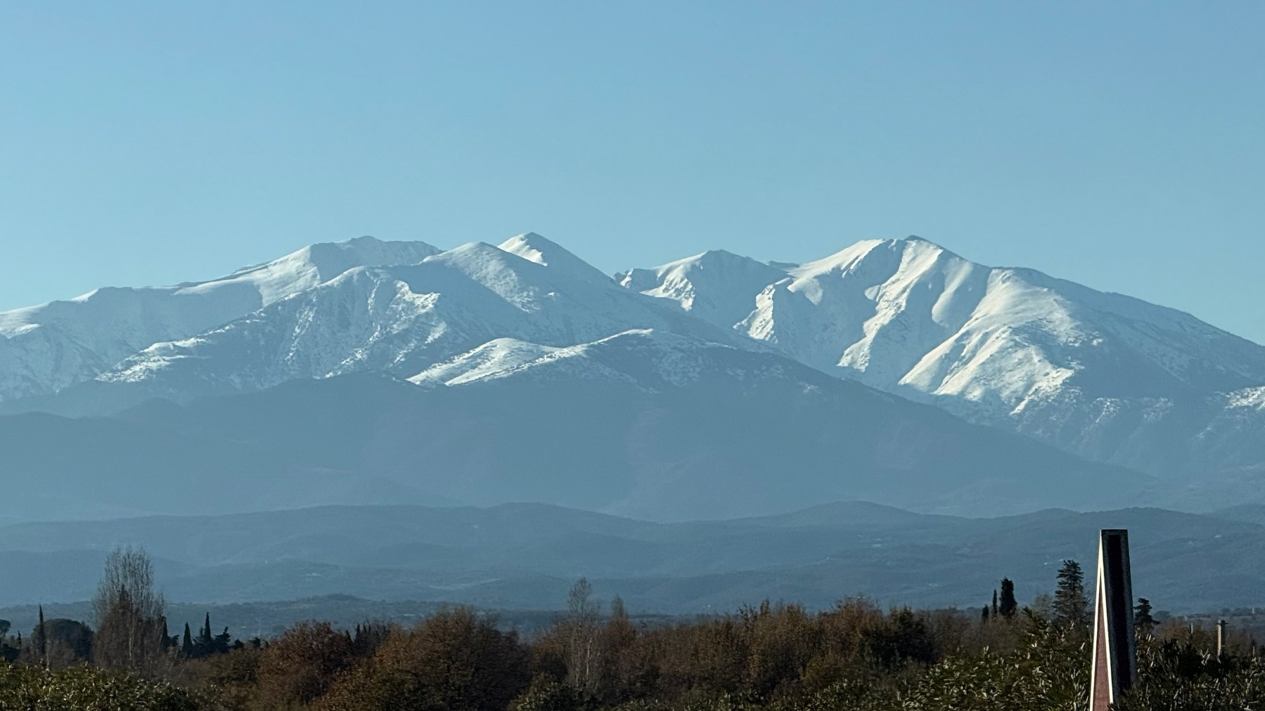 photograph of a large snow capped mountain